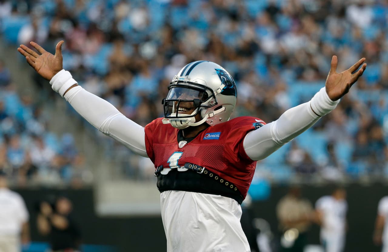 Carolina Panthers' Cam Newton (1) plays to the crowd during practice at the NFL football team's Fan Fest in Charlotte, N.C., Friday, Aug. 4, 2017. (AP Photo/Chuck Burton)