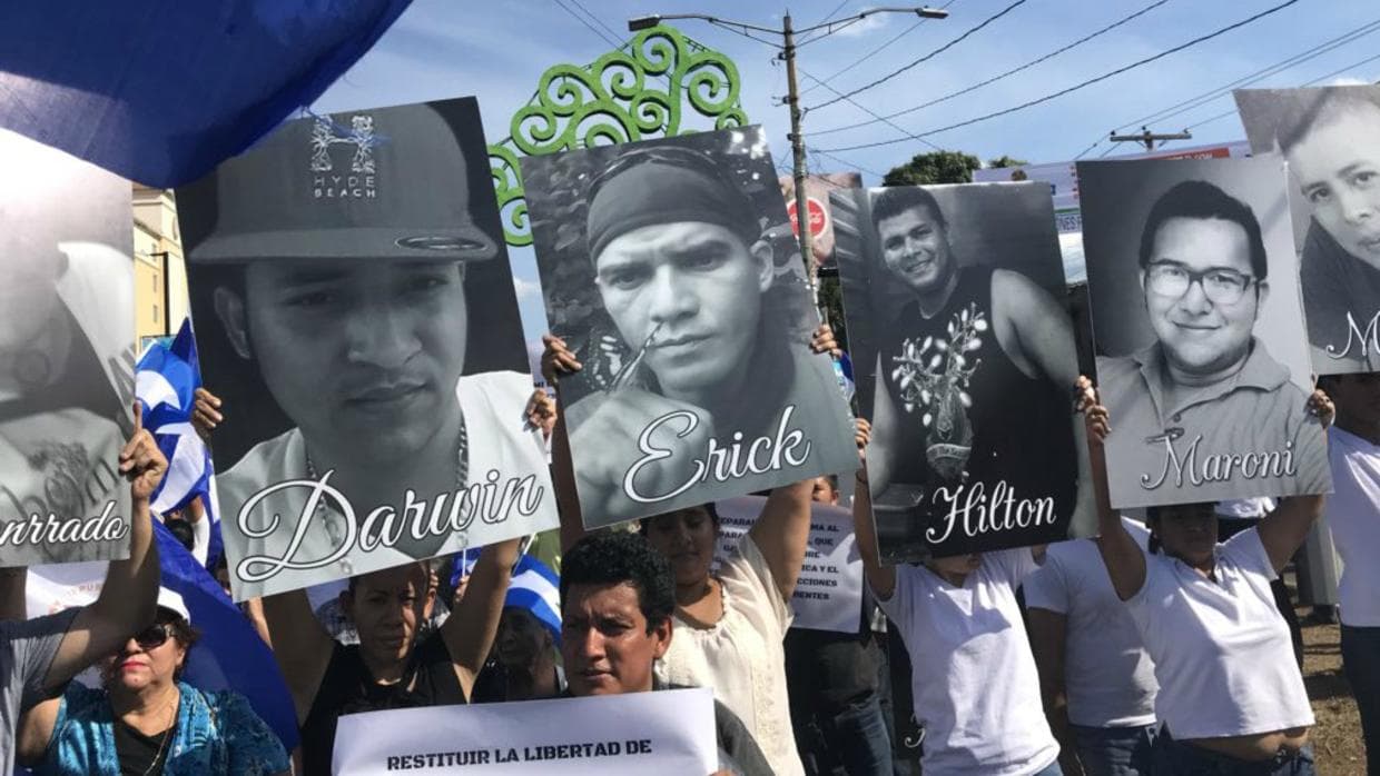 Protesters in Managua, Nicaragua hold images of fellow students killed in anti-government demonstrations during a march on April 23, 2018.