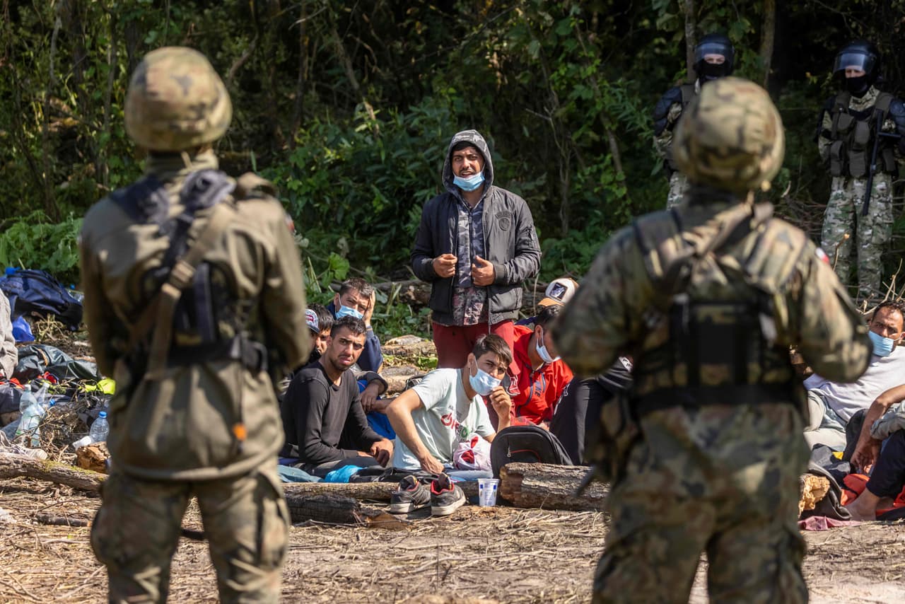 Guardias fronterizos polacos (en primer plano) y bielorrusos (al fondo) junto a un grupo de migrantes afganos el 20 de agosto. 
<a href="https://www.dw.com/en/afghan-migrants-trapped-at-the-border-between-poland-and-belarus/a-58973715"><u>Fueron detenidos cerca de Bialystok</u></a>, una ciudad fronteriza polaca a unas 2,500 millas de Kabul. Es la misma distancia que hay entre la Ciudad de Guatemala y San Francisco, California, por ejemplo.