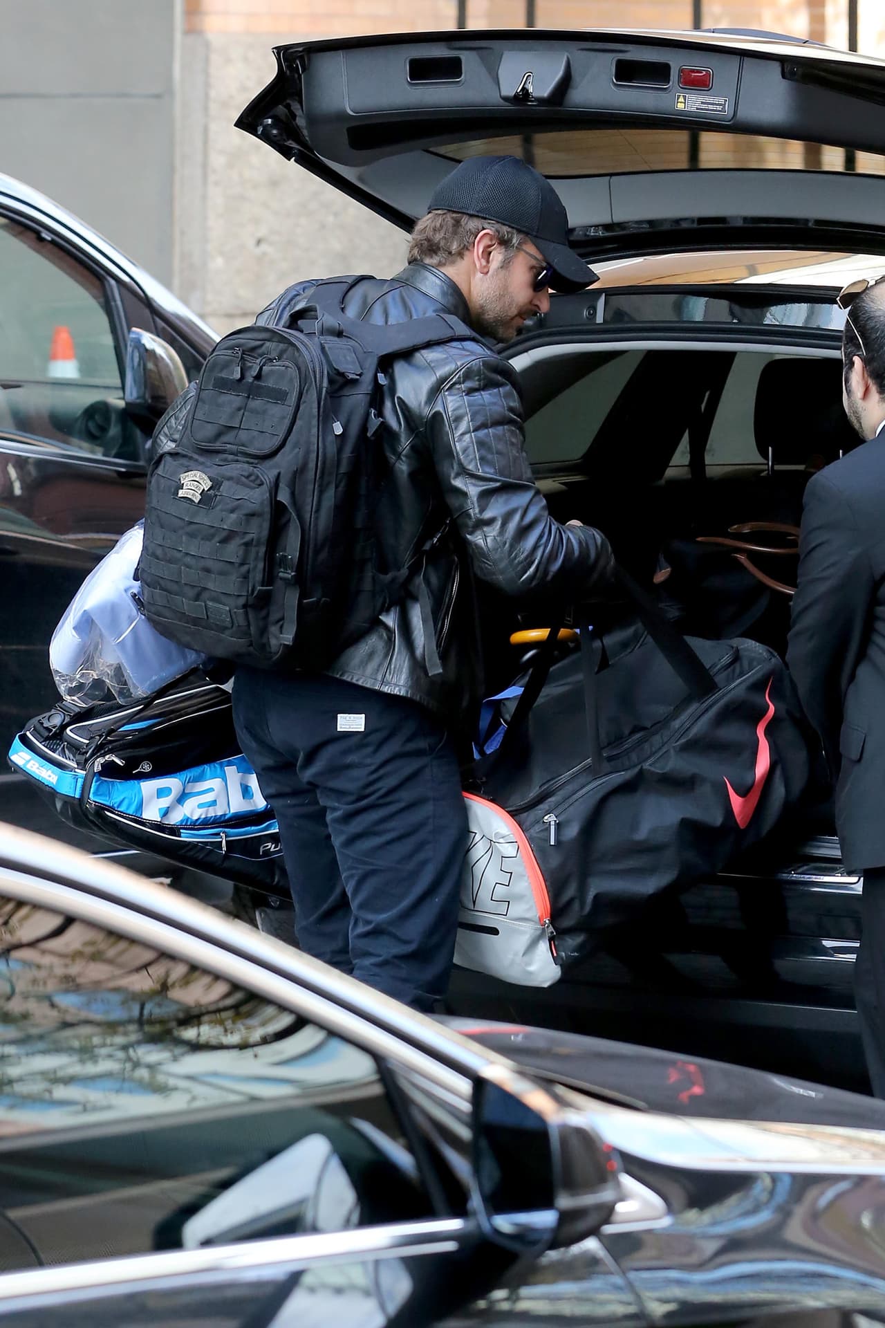 Un asistente le ayudaba a sacar cosas de la cajuela del vehículo.