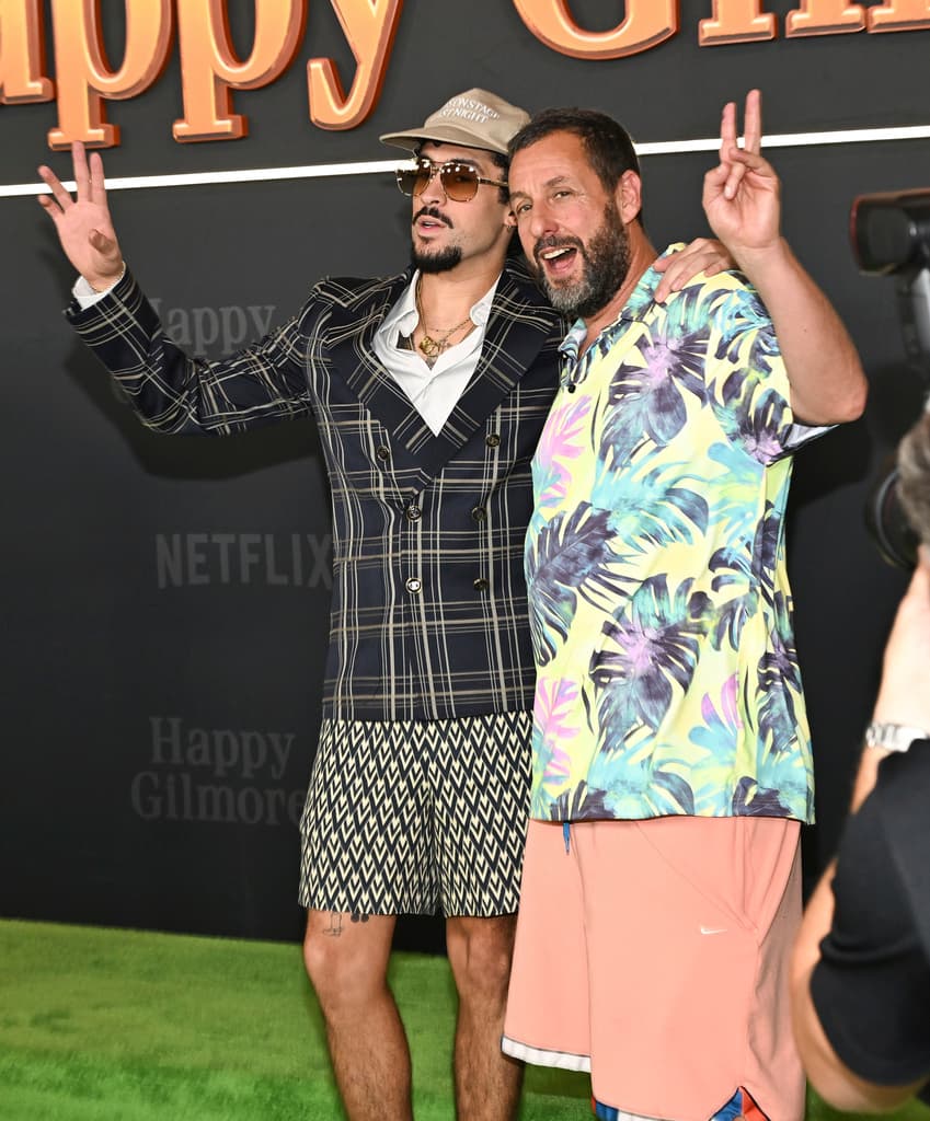 Benito Antonio Martinez Ocasio (aka Bad Bunny), left, and Adam Sandler attend the premiere of Netflix's "Happy Gilmore 2" at Jazz at Lincoln Center on Monday, July 21, 2025, in New York. (Photo by Evan Agostini/Invision/AP)