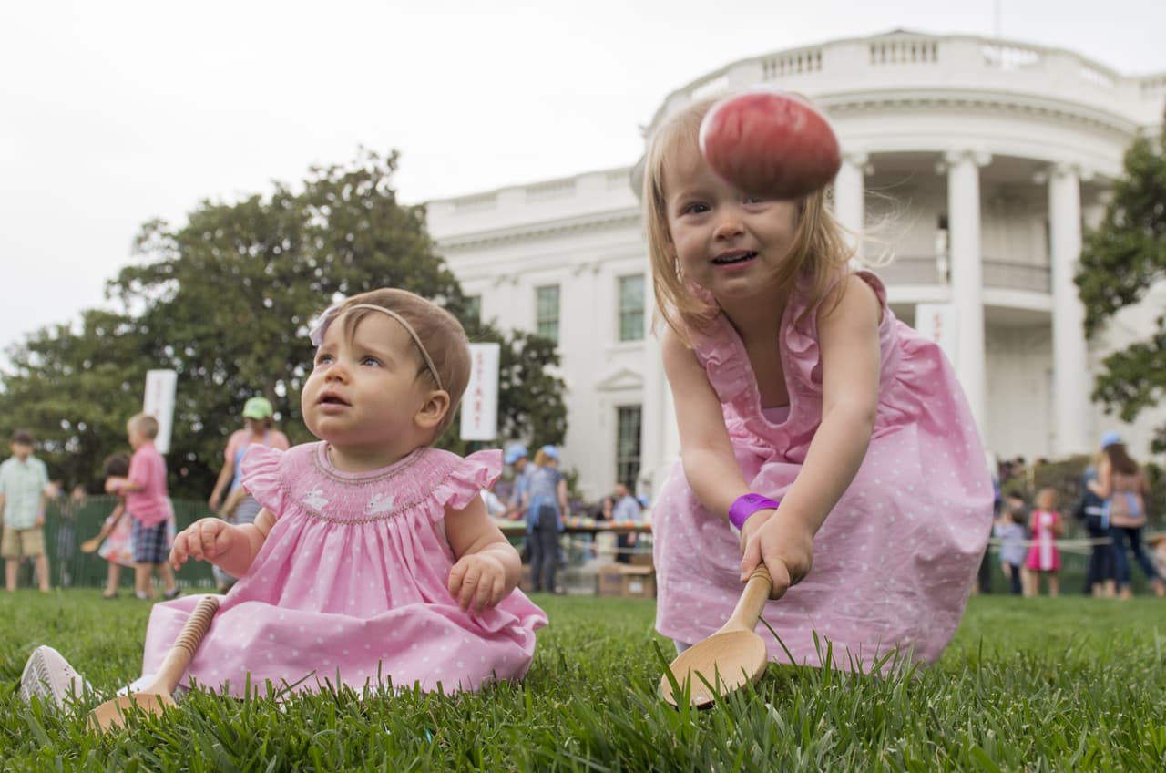 Abigail, de tres años de edad y Caroline, de diez meses, participan en una carrera de huevos de Pascua, en el jardín sur de la Casa Blanca.