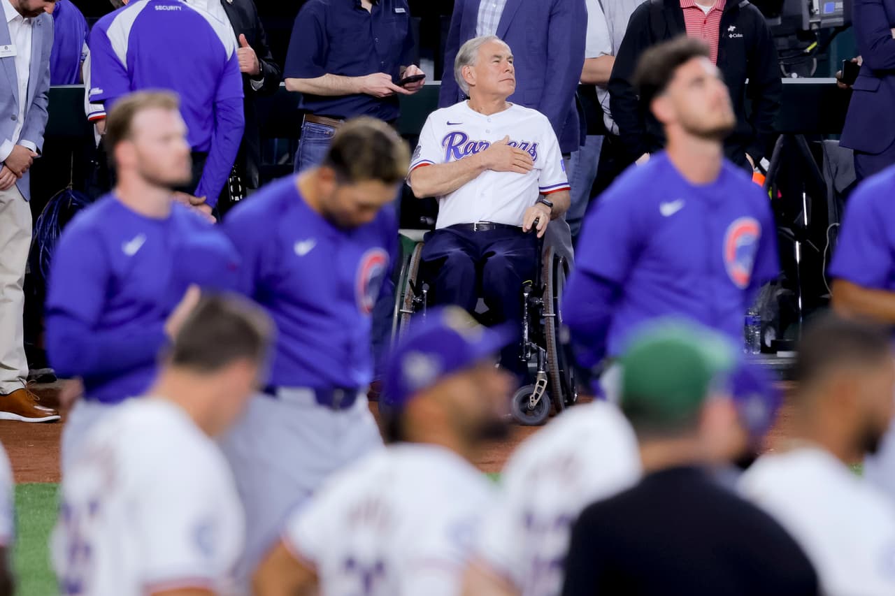 El
<a href="https://www.univision.com/temas/greg-abbott" target="_blank">Gobernador Greg Abbott</a> en el himno nacional del partido de apertura de los Texas Rangers y los Chicago Cubs en el Globe Life Field de Arlington.