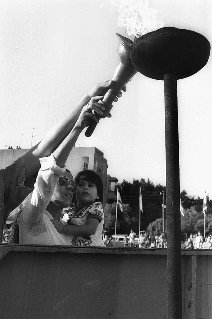 En la fotografía, Ankie Spitzer, viuda de Andre Spitzer, prende una antorcha junto a su pequeño en la ceremonia de homenaje por el segundo aniversario de la masacre de Múnich, en Tel Aviv, Israel.