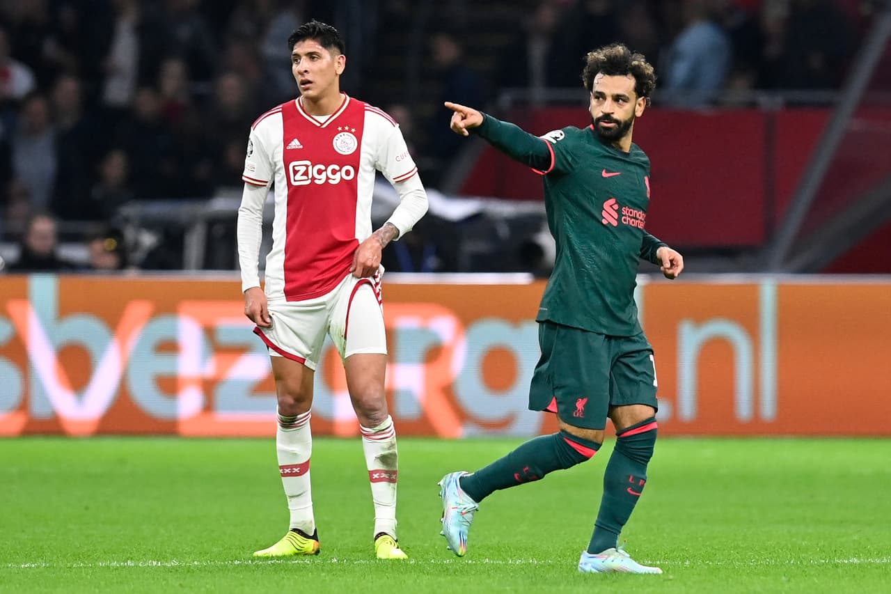 Liverpool's Egyptian striker Mohamed Salah (R) celebrates scoring his team's first goal as Ajax's Mexican defender Edson Alvarez (L) looks on during the UEFA Champions League group A football match between Ajax Amsterdam and Liverpool at the Johan Cruijff ArenA in Amsterdam, on October 26, 2022. (Photo by JOHN THYS / AFP) (Photo by JOHN THYS/AFP via Getty Images)