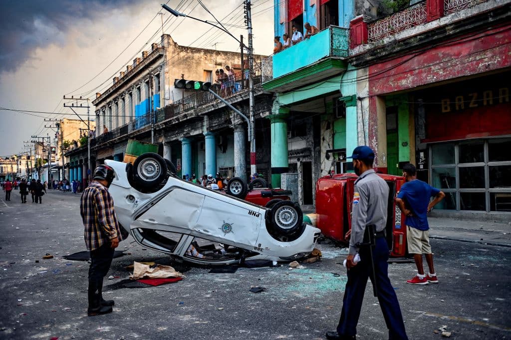 Police cars are seen overturned in the street in the framework of a demonstration against Cuban President Miguel Diaz-Canel in Havana, on July 11, 2021.