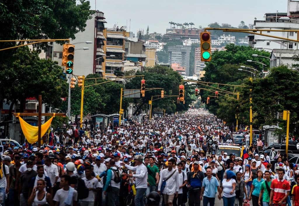 Cientos de personas caminaron kilómetros desde el este hasta el oeste de Caracas para llegar a la Conferencia Episcopal Venezolana, lugar donde se concentraron los opositores este sábado para protestar contra el gobierno de Nicolás Maduro. (Juan Barreto/AFP/GettyImages)