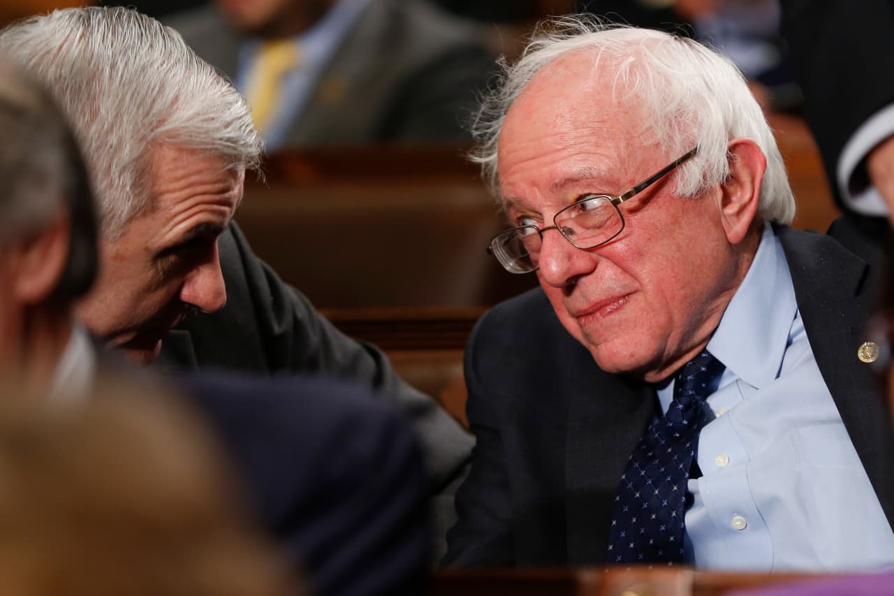 El candidato presidencial demócrata, el senador Bernie Sanders, habla con el senador Jack Reid.