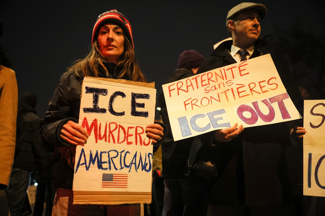 Protesters hold placards that reads: "ICE murders Americans" and "Brotherhood without borders ICE out", gathered next to the French foreign ministry in Paris to denounce the crackdown of U.S. Immigration and Customs Enforcement (ICE) in Paris, Wednesday Jan. 28. 2026. (AP Photo/Thomas Padilla)
