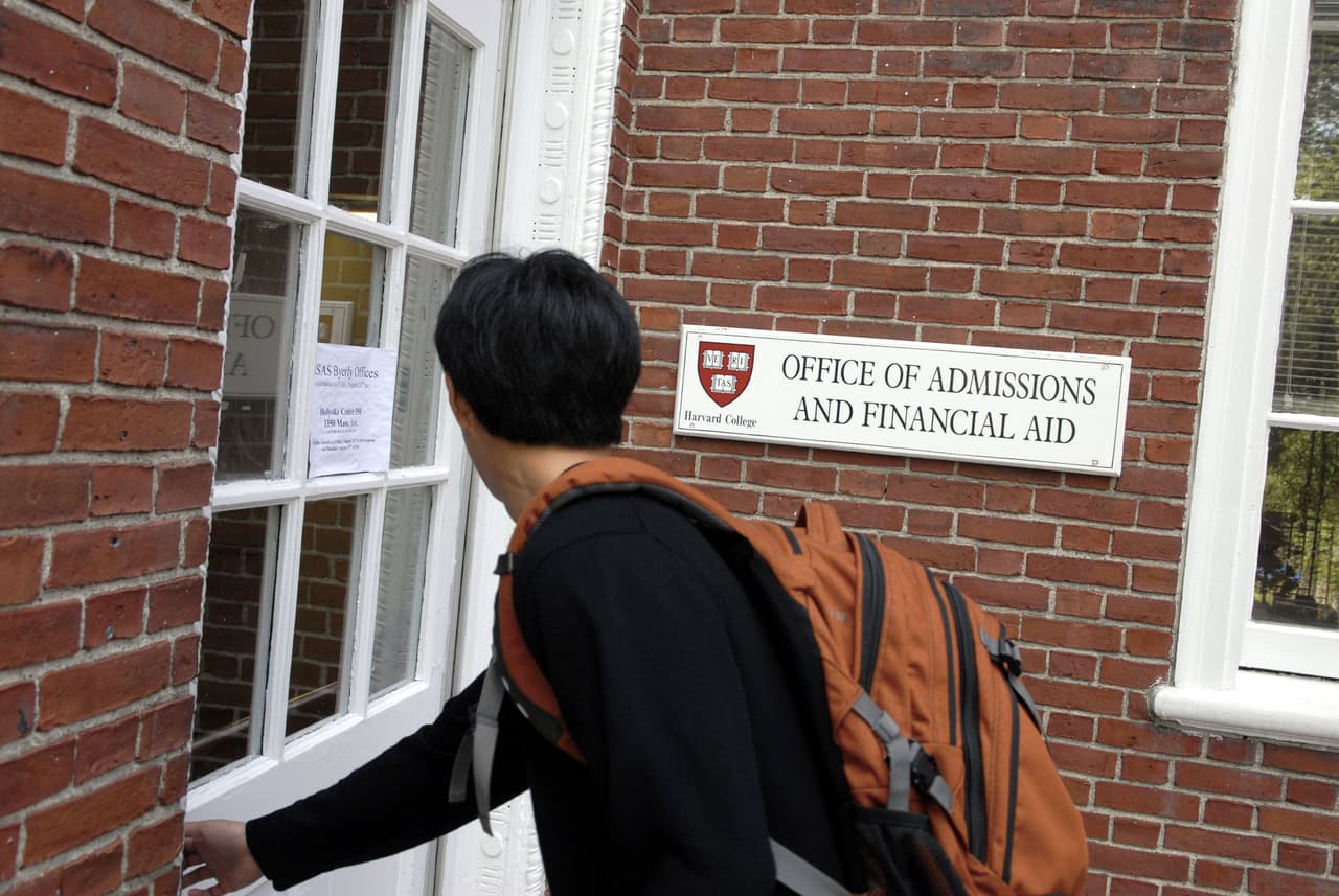 CAMBRIDGE, MA - SEPTEMBER 12: Freshman Winston Yan enters the Admissions Building at Harvard University September 12, 2006 in Cambridge, Massachusetts. Harvard is eliminating early admissions beginning next year because of criticism that it favors wealthier students and hinders those seeking financial aid since the deadlines for aid are much later. (Photo by Glen Cooper/Getty Images)