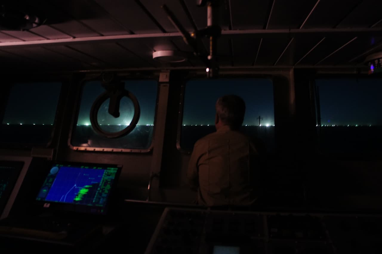 Desde el puente del Prefecto Derbes mientras realiza una patrulla nocturna, se pueden ver las luces de la flota pesquera extranjera.