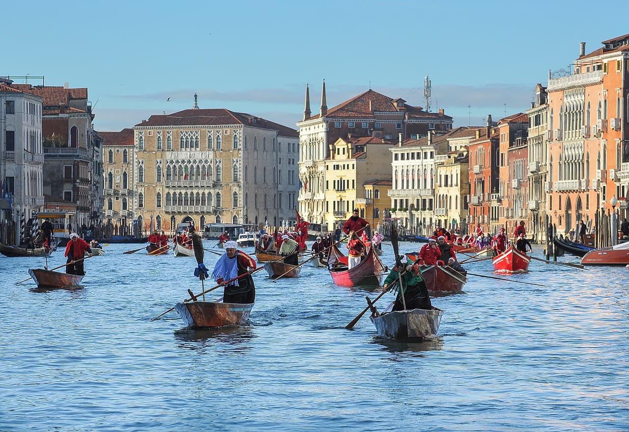 VENICE, ITALY - JANUARY 06: Rowers dressed in costume race along the Grand Canal for the "Befana" Regatta on January 6, 2014 in Venice, Italy. In Italian folklore, Befana is an old woman who delivers gifts to children throughout Italy on the feast of the Epiphany on January 6 in a similar way to Saint Nicholas or Santa Claus. (Photo by Marco Secchi/Getty Images)
