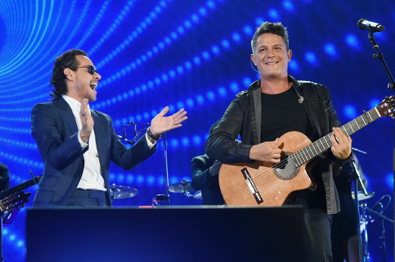 MIAMI, FL - OCTOBER 14: In this handout photo provided by One Voice: Somos Live!, Marc Anthony and Alejandro Sanz perform onstage at One Voice: Somos Live! A Concert For Disaster Relief at Marlins Park on October 14, 2017 in Miami, Florida. (Photo by Rick Diamond/One Voice: Somos Live!/Getty Images)