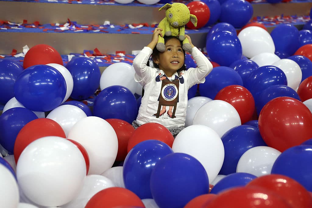 Una pequeña asistente juega con globos durante la Convención Nacional Demócrata en Philadelphia, Pennsylvania.