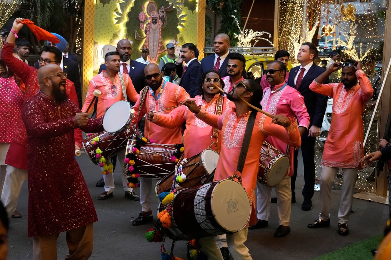 Anant Ambani, son of Chairman of Reliance Industries Limited, Mukesh Ambani, centre, smiles as he shares a light moment, during his pre-wedding ceremony to Radhika Merchant, at his residence Antilia in Mumbai, India, Wednesday, July 3, 2024. (AP Photo/Rafiq Maqbool)