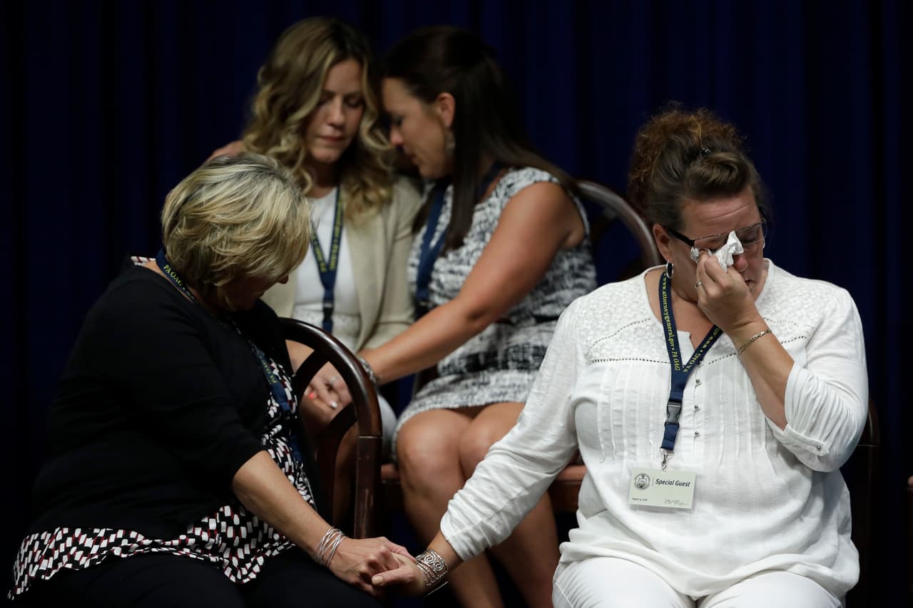 FILE - In this Aug. 14, 2018, file photo victims of clergy sexual abuse, or their family members, react as Pennsylvania Attorney General Josh Shapiro speaks during a news conference at the State Capitol in Harrisburg, Pa. Over the past four months, Roman Catholic dioceses across the U.S. have released the names of more than 1,000 priests and others accused of sexually abusing children in an unprecedented public reckoning spurred at least in part by a shocking grand jury investigation in Pennsylvania, an Associated Press review has found. (AP Photo/Matt Rourke, File)