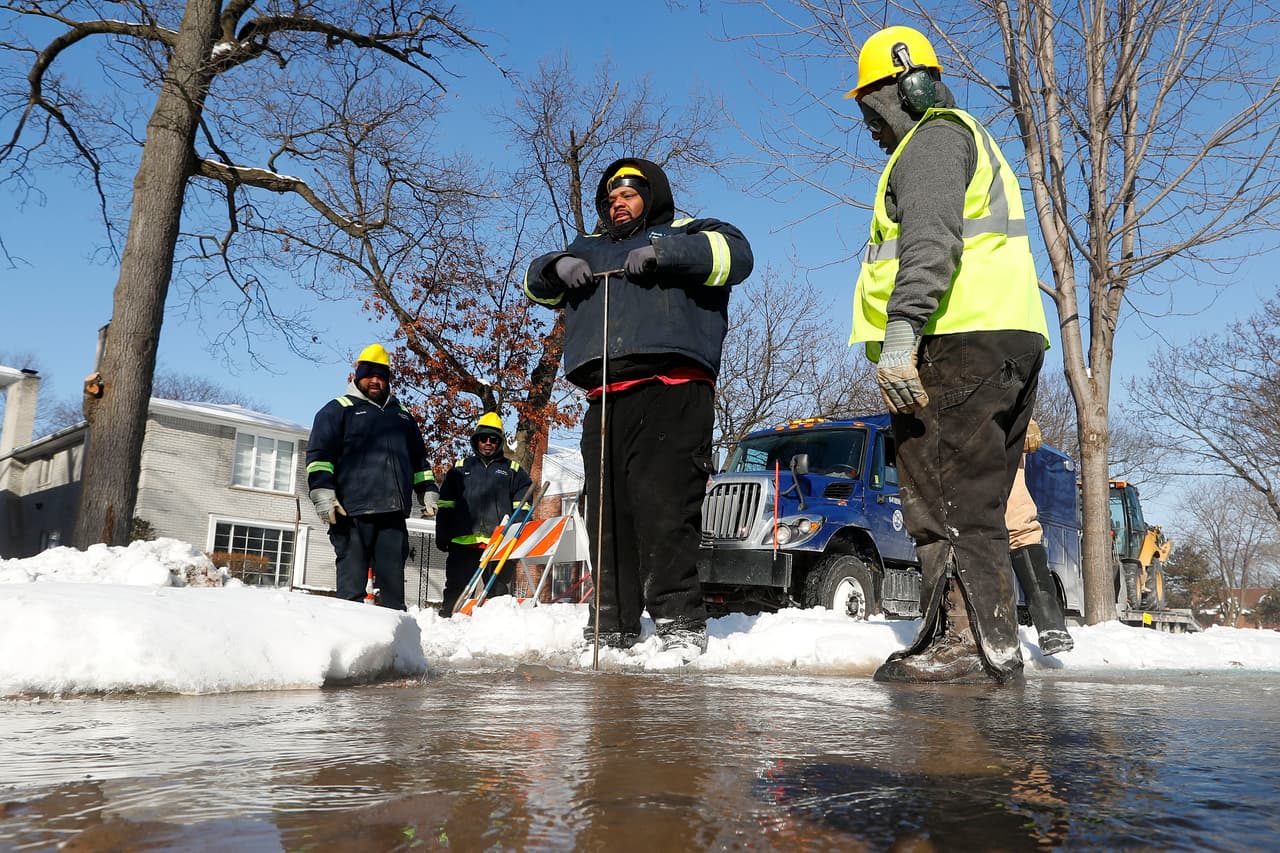 Trabajadores de la compañía de Agua y servicios de Detroit trabajan en las calles heladas por la ola de frío.