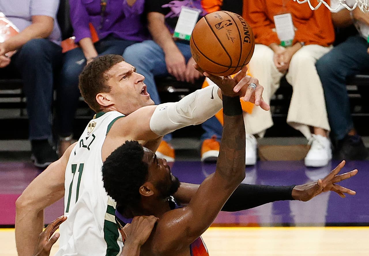 Brook Lopez # 11 de los Milwaukee Bucks comete una falta a Deandre Ayton # 22 de los Phoenix Suns durante la segunda mitad del segundo juego.
