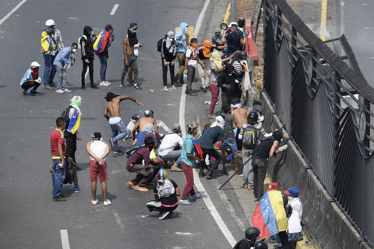 Pese a los llamados de la oposición y de algunos países que reconocen a Guaidó como presidente interino, los altos mandos militares hasta ahora se han mantenido alineados con Maduro. En la foto un grupo de manifestantes en una refriega con militares frente a la base aérea La Carlota.