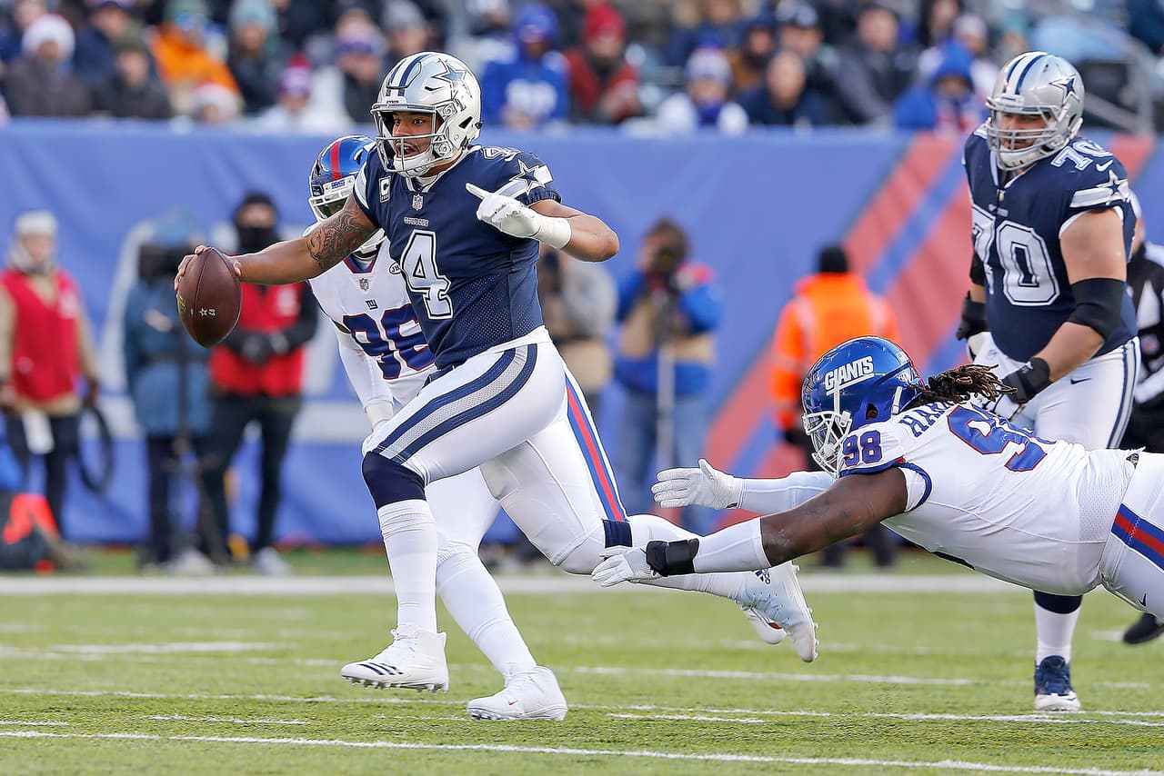 Dallas Cowboys quarterback Dak Prescott (4) scrambles away from New York Giants defensive tackle Damon Harrison Sr. (98) during a 2017 NFL week 14 regular season game, Sunday, Dec. 10, 2017 in East Rutherford, N.J. The Cowboys defeated the Giants, 30-10. (James D. Smith via AP)