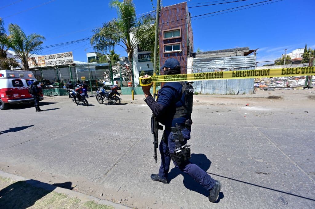 A policeman secures the area where a man was murdered inside his truck in Fresnillo, in Zacatecas state, Mexico, on March 15, 2022.