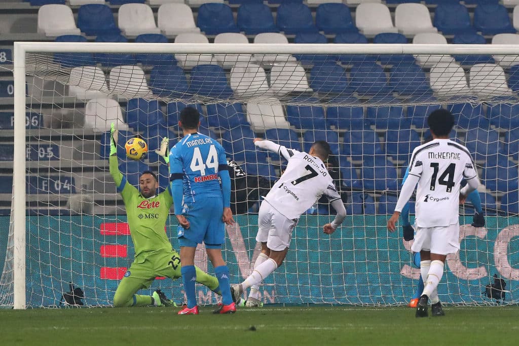 REGGIO NELL'EMILIA, ITALY - JANUARY 20: Cristiano Ronaldo of Juventus scores their sides first goal during the Italian PS5 Supercup match between Juventus and SSC Napoli at Mapei Stadium - Citta' del Tricolore on January 20, 2021 in Reggio nell'Emilia, Italy. Sporting stadiums around Italy remain under strict restrictions due to the Coronavirus Pandemic as Government social distancing laws prohibit fans inside venues resulting in games being played behind closed doors. (Photo by Marco Luzzani/Getty Images)