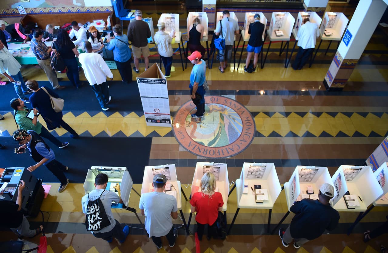 People vote on the US presidential election at Santa Monica City Hall on November 8, 2016 in Santa Monica, California. America's future hung in the balance Tuesday as millions of eager voters cast ballots to elect Democrat Hillary Clinton as their first woman president, or hand power to the billionaire populist Donald Trump. / AFP / Frederic J. BROWN (Photo credit should read FREDERIC J. BROWN/AFP/Getty Images)