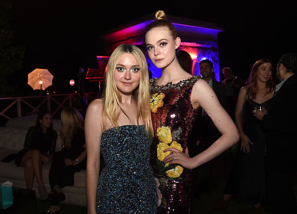LOS ANGELES, CA - JUNE 14: Actresses Dakota Fanning (L) and Elle Fanning pose at the after party for the premiere of Amazon's "The Neon Demon" at the Hollywood Forever Cemetery on June 14, 2016 in Los Angeles, California. (Photo by Kevin Winter/Getty Images)
