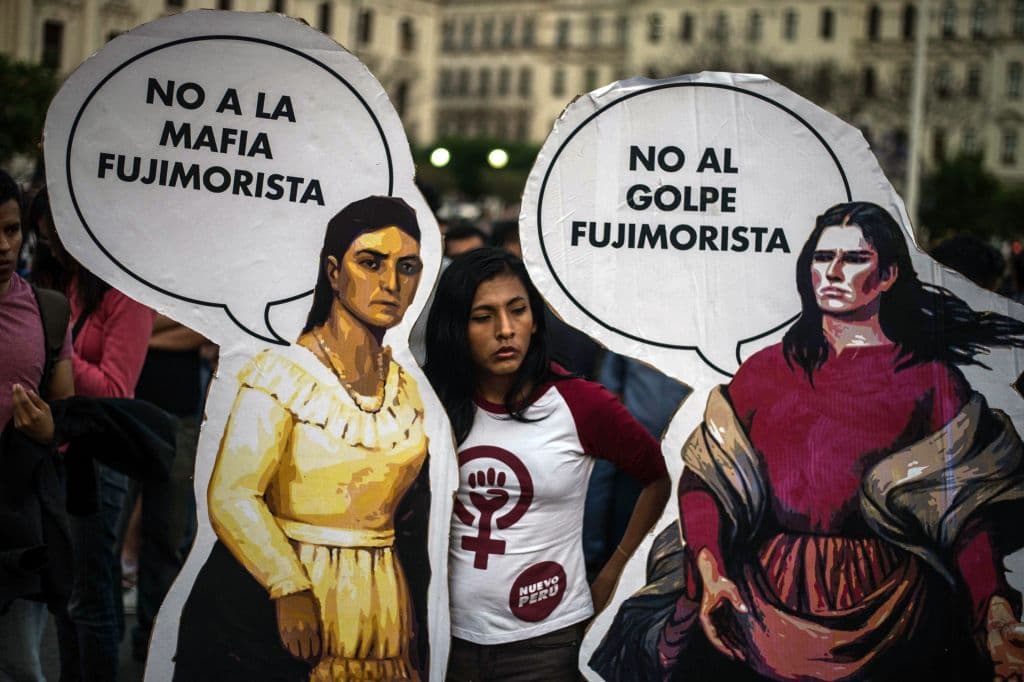 People protest against Fujimorism and corruption in Lima on December 20, 2017, as the presidency of Pedro Pablo Kuczynski hangs in the balance while the opposition, which controls Congress, demands he steps down or face impeachment over graft allegations linked to Brazilian construction giant Odebrecht. / AFP PHOTO / Ernesto BENAVIDES (Photo credit should read ERNESTO BENAVIDES/AFP/Getty Images)