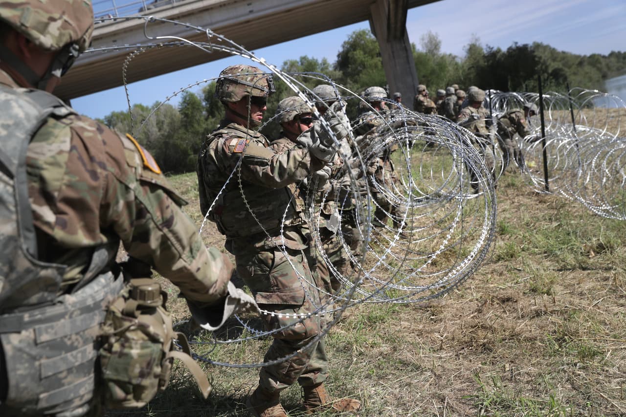 HIDALGO, TX - NOVEMBER 02: U.S. Army soldiers from Ft. Riley, Kansas install protective wire along the Rio Grande at the U.S.-Mexico border on November 2, 2018 in Hidalgo, Texas. U.S. President Donald Trump ordered the troops to the border to bolster security at points of entry where an immigrant caravan may attempt to cross in upcoming weeks. The troops in Hidalgo were from the 97th MP Battalion and had arrived to the Rio Grande Valley the day before. (Photo by John Moore/Getty Images)
