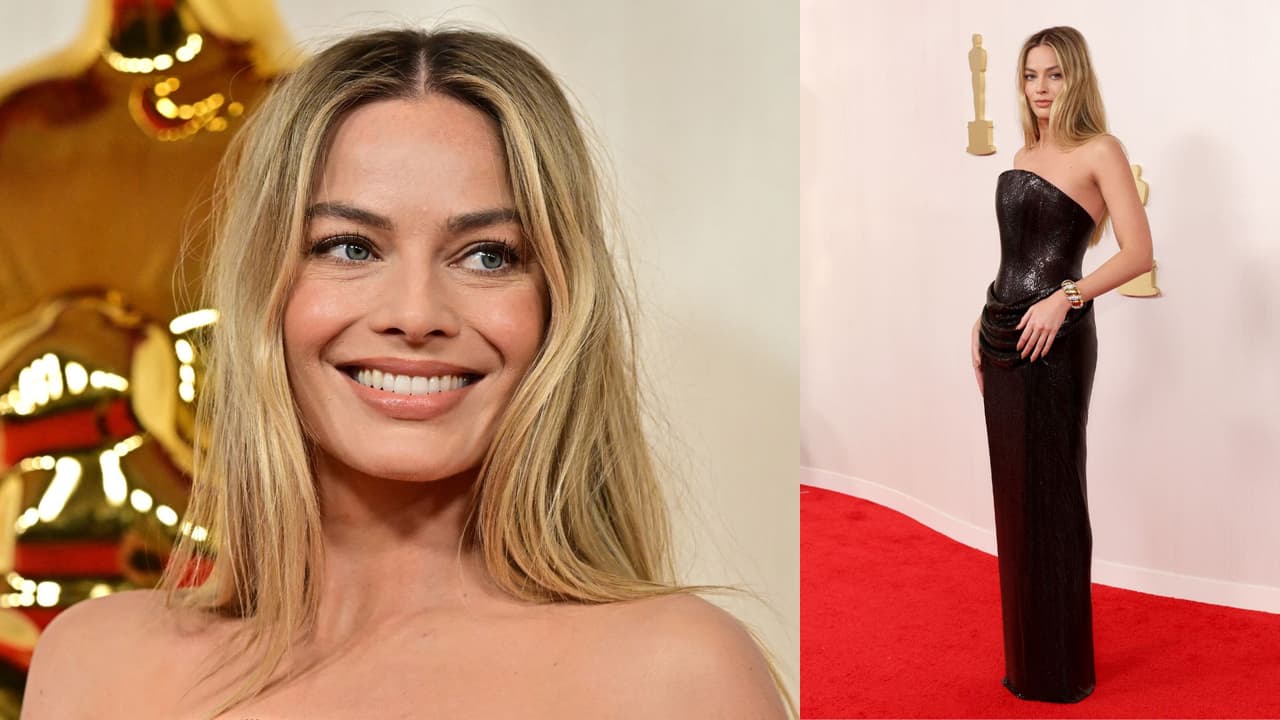 Margot Robbie, protagonista de 'Barbie', asistió a los Premios Oscar 2024 utilizando un vestido negro, con corte columna y un estratégico drapeado a la altura de la cadera, de Versace.