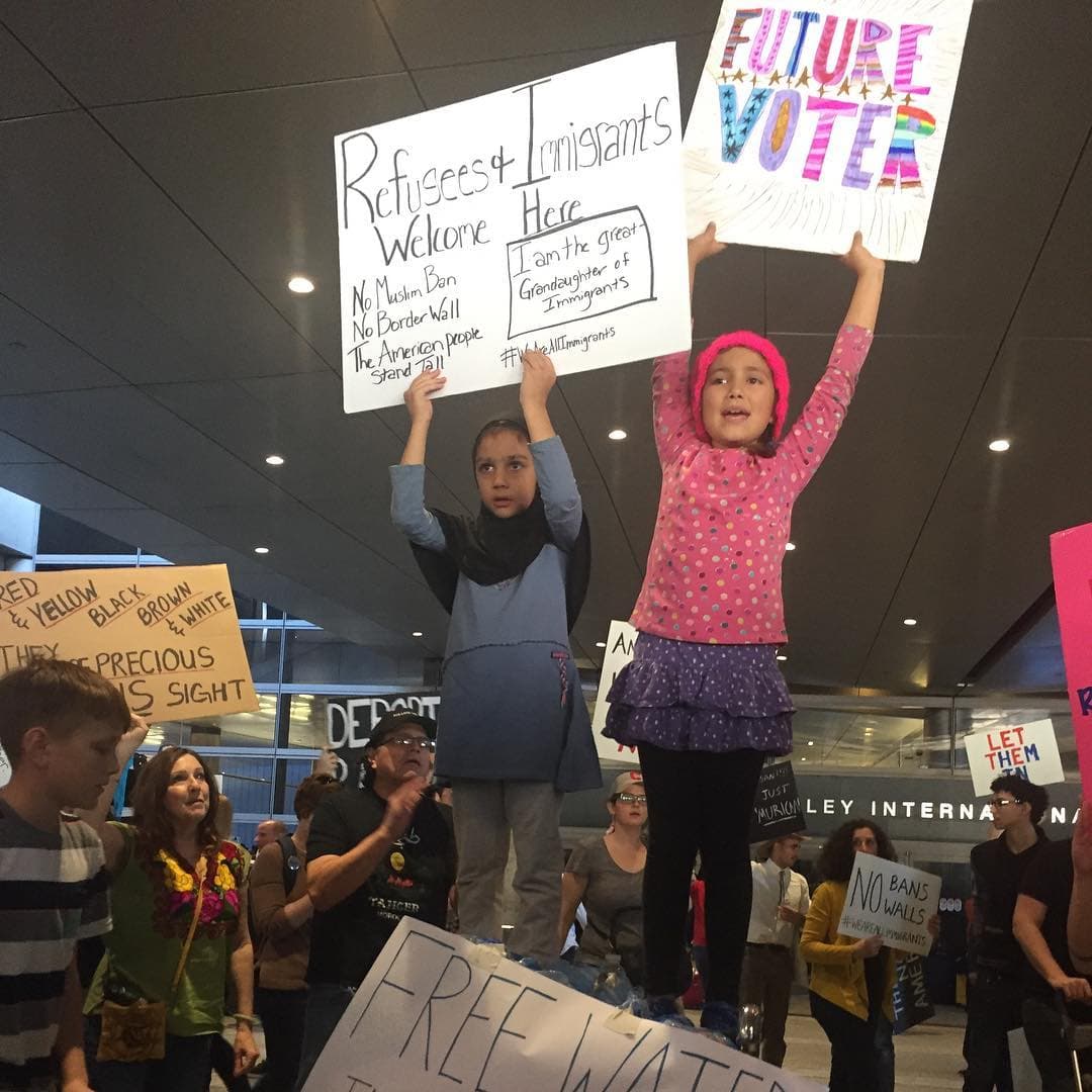 "Refugiados e inmigrantes bienvenidos"; "Futura votante"