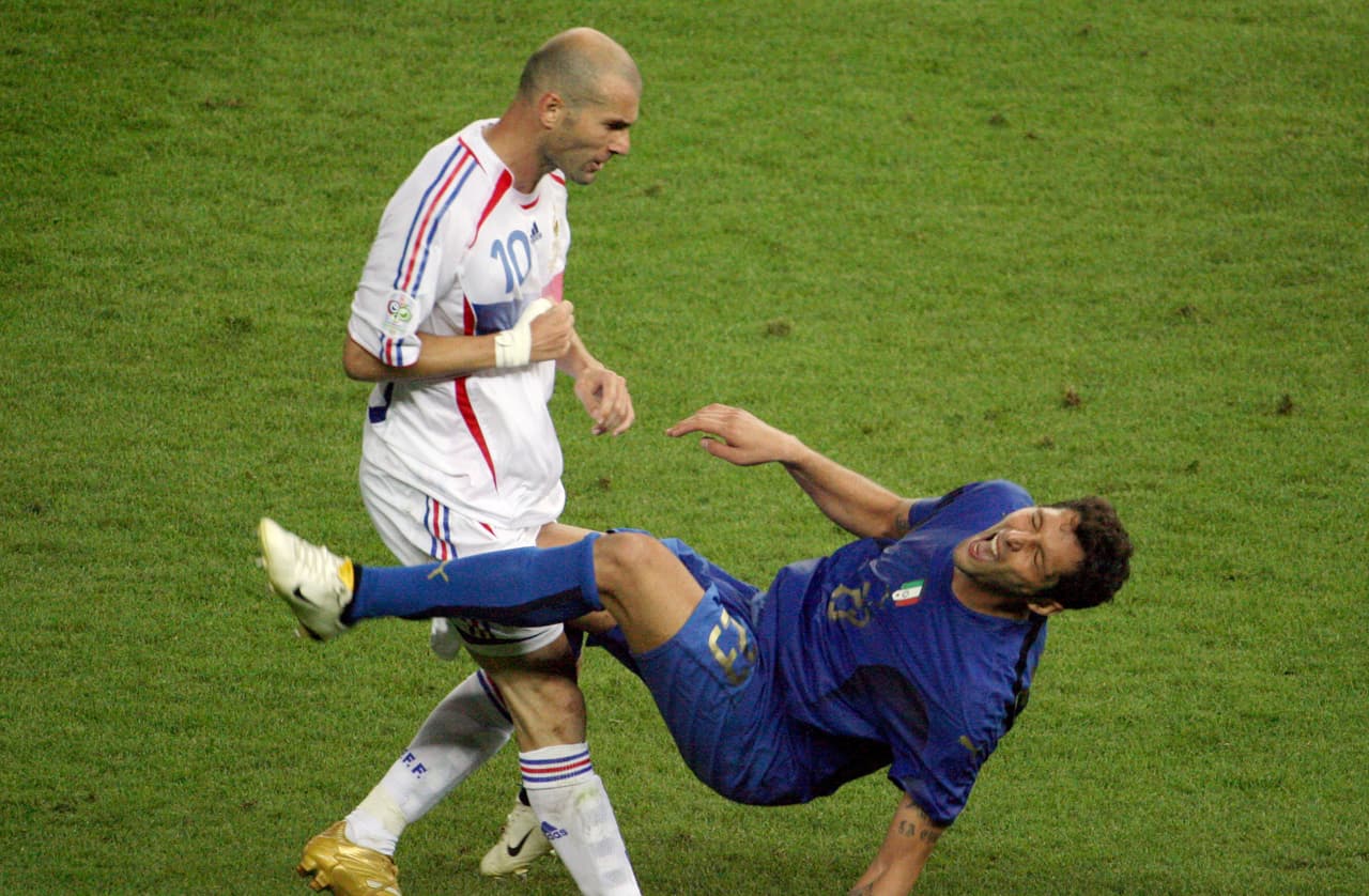 A photo taken 09 July 2006 shows French midfielder Zinedine Zidane (L) gesturing after head-butting Italian defender Marco Materazzi during the World Cup 2006 final football match between Italy and France at Berlins Olympic Stadium. AFP PHOTO JOHN MACDOUGALL / AFP / JOHN MACDOUGALL (Photo credit should read JOHN MACDOUGALL/AFP/Getty Images)