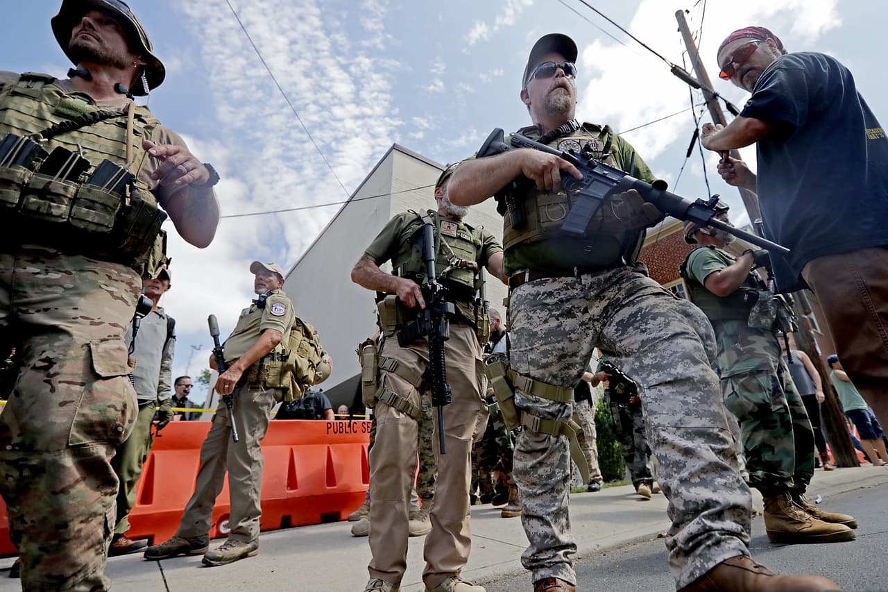 CHARLOTTESVILLE, VA - AUGUST 12: White nationalists, neo-Nazis and members of the "alt-right" with body armor and combat weapons evacuate comrades who were pepper sprayed after the "Unite the Right" rally was delcared a unlawful gathering by Virginia State Police August 12, 2017 in Charlottesville, Virginia. After clashes with anti-fascist protesters and police the rally was declared an unlawful gathering and people were forced out of Emancipation Park, where a statue of Confederate General Robert E. Lee is slated to be removed. (Photo by Chip Somodevilla/Getty Images)