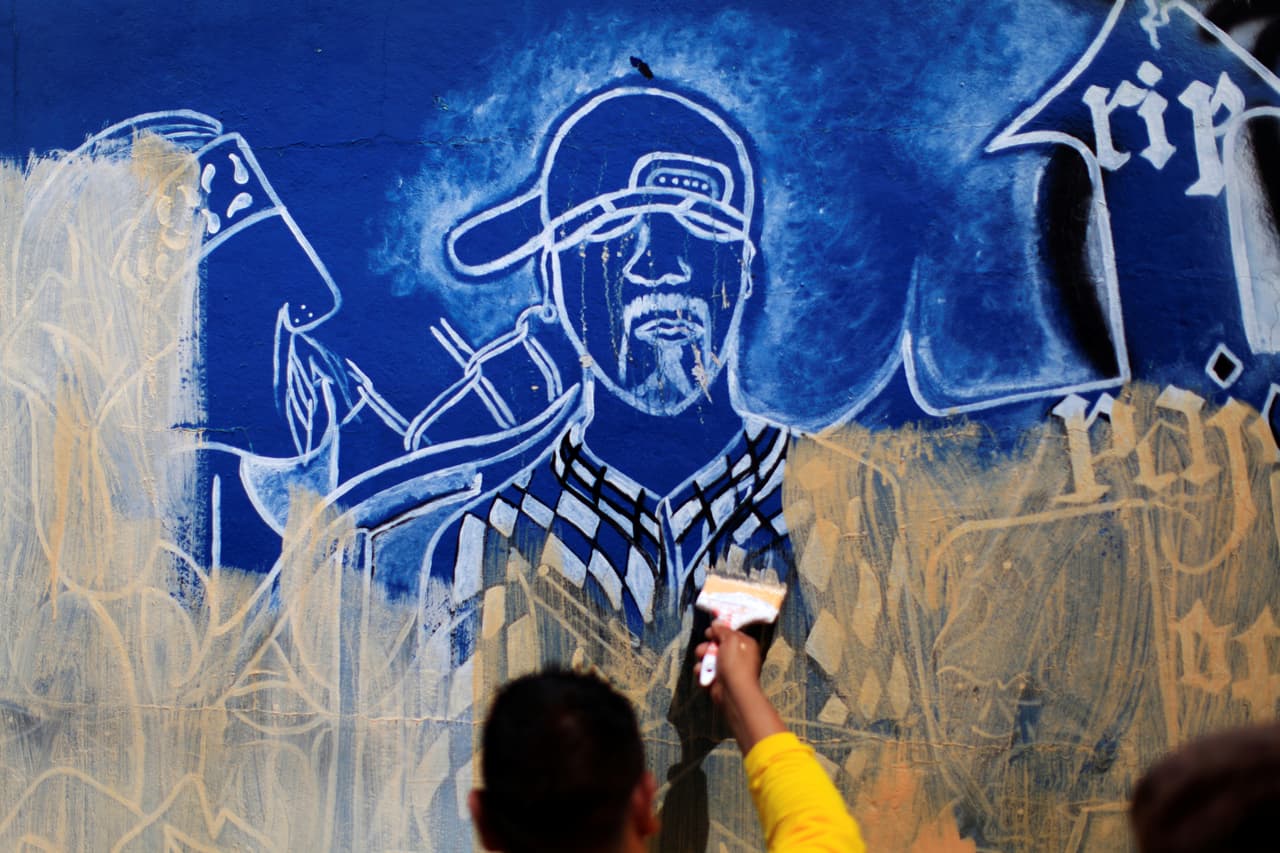 Un reo en libertad condicional pinta un muro para ocultar un grafiti de la ‘Mara Salvatrucha’ en Soyapango, El Salvador, junio de 2016. Los intentos de reinserción de varias organizaciones, apoyadas por los gobiernos centroamericanos, no parecen suficientes para frenar la expansión de la violencia. 
<br>Recientes cambios en la política estadounidense podrían facilitar la concesión de asilo a centroamericanos víctimas de la violencia, pero en sus países de origen. Los inmigrantes centroamericanos que buscan asilo y entraron al país sin documentos después del 1 de enero de 2014, están en la lista de prioridades de deportación del gobierno de Obama. Su gestión 
<a href="http://www.univision.com/noticias/deportaciones/obama-es-el-presidente-que-mas-ha-deportado-en-los-ultimos-30-anos"><b>ha regresado a sus países a mas de 2.7 millones de inmigrantes indocumentados</b></a> desde enero de 2009. Muchos de ellos habían escapado de amenazas directas de las maras en sus países.