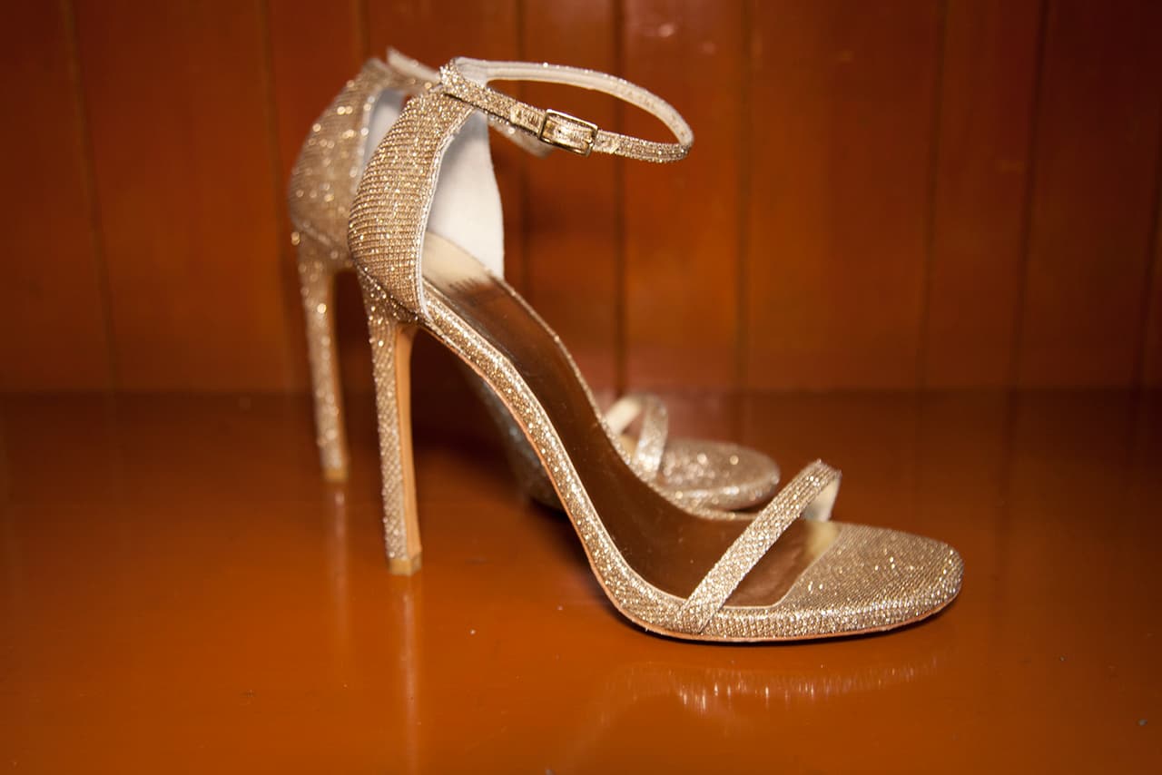 Los zapatos eran las clásicas Nudists: unas strap sandals altas en glitter dorado de la marca 
<a href="https://www.stuartweitzman.com/store/item/?itemid=134950&gclid=CjwKCAjwwJrbBRAoEiwAGA1B_Zjq8p62CMBuTXZ28CY5jDS3KehBK3MZXBBI-rxexIAsx5Dcf5dKvBoCUrAQAvD_BwE">Stuart Weitzman</a> ($425 dólares), unas de las favoritas de las famosas en las alfombras rojas.