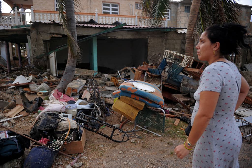 Una mujer contempla cómo quedaron destruidas la calle y su hogar en La Habana tras el paso de Irma, que dejó al menos 10 muertos en la isla, antes de seguir su camino a Florida, que ya se preparaba desde días atrás ante la incierta trayectoria del huracán.