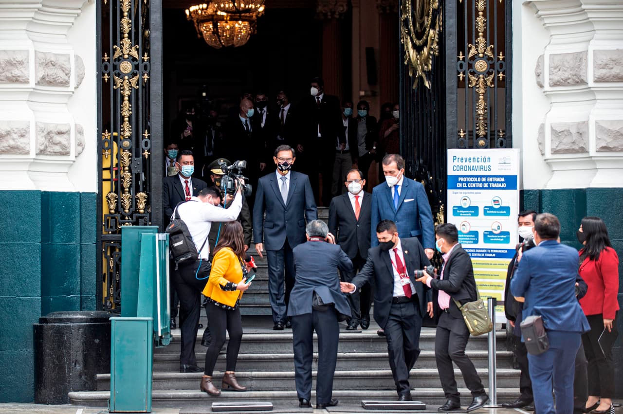 Vizcarra (en el centro) al abandonar el Congreso luego de dar su declaración por su segundo juicio político. Esta vez se le acusó de 
<b>presuntamente haber recibido sobornos por contratos de obras públicas en 2014, cuando era gobernador de la sureña región de Moquegua.</b>