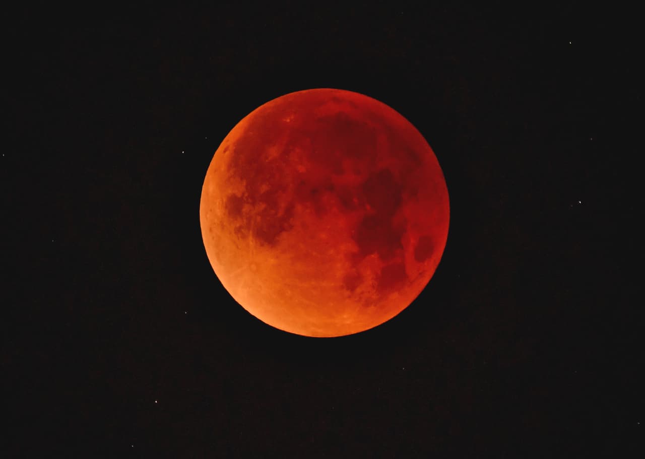 WHITTIER, CA - JANUARY 31: A so-called 'super blue blood moon' descends over downtown Los Angeles skyline January 31, 2018 seen from Whittier, California. The Super Blue Blood Moon is a rare 'lunar trifecta' event in which the Moon is at its closest to the Earth, appearing about 14 percent brighter than usual, and is simultaneously a 'blue moon', the second full moon in the same month, as well as a total lunar eclipse or 'blood moon'. Such a lunar event that hasn't been seen since 1866. (Photo by Nick Ut/Getty Images)