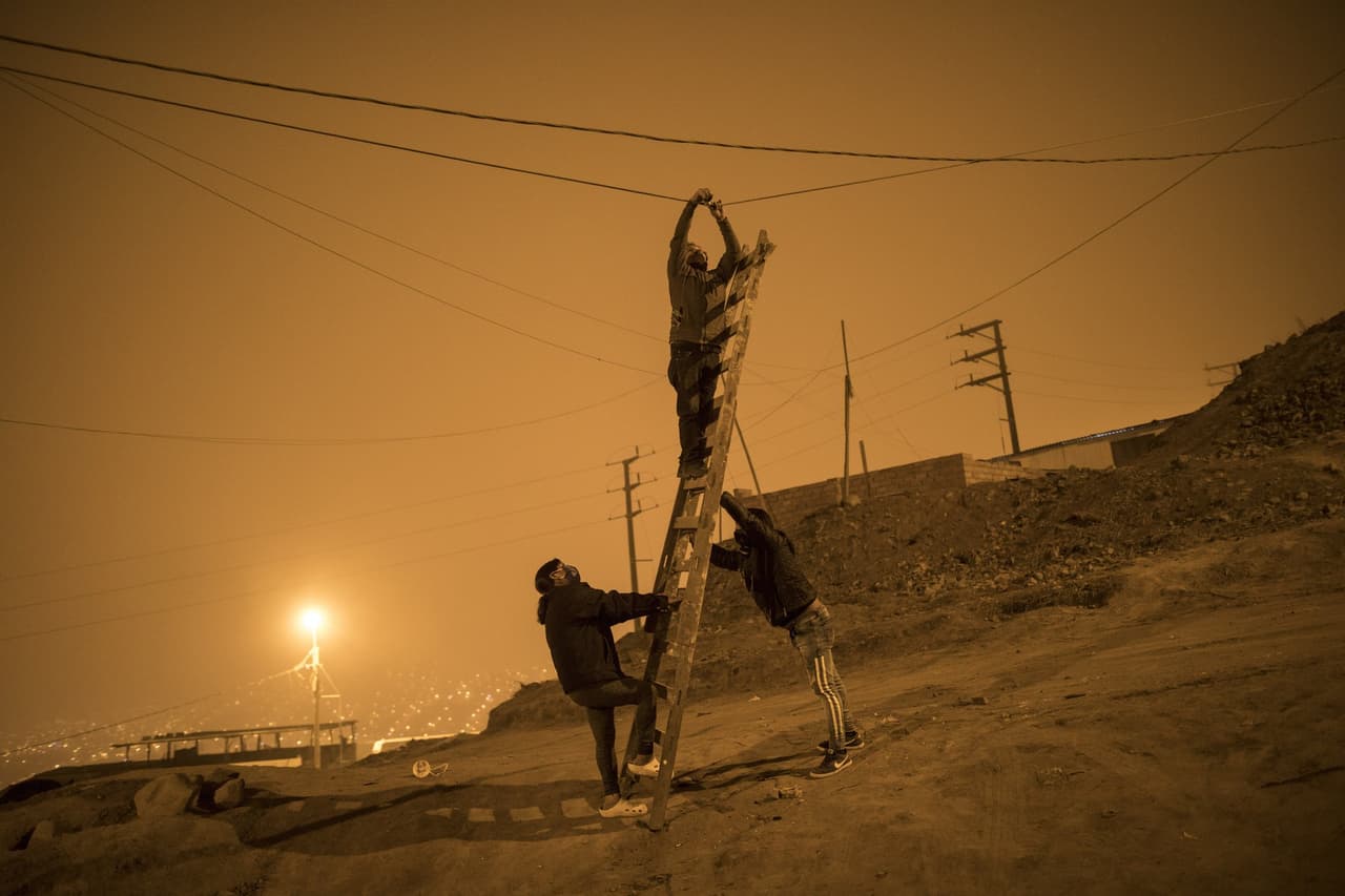Aunque el panorama luce desolador y muy cuesta arriba, 
<b>Nueva Esperanza es uno de los muchos ejemplos en América Latina sobre la solidaridad y empatía de una región ya de por sí golpeada</b>, en la que esperar auxilio del gobierno puede tomar mucho tiempo. 
<br>
<br>En la imagen, tres vecinos se ayudan para arreglar un cable de luz que provocó un apagón en todo el barrio.