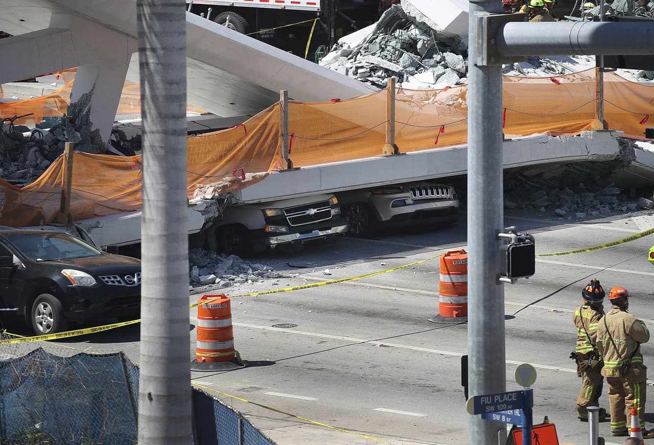 MIAMI, FL - MARCH 15: Vehicles are seen trapped under the collapsed pedestrian bridge that was newly built over southwest 8th street allowing people to bypass the busy street to reach Florida International University on March 15, 2018 in Miami, Florida. Reports indicate that there are an unknown number of fatalities as a result of the collapse, which crushed at least five cars. (Photo by Joe Raedle/Getty Images)