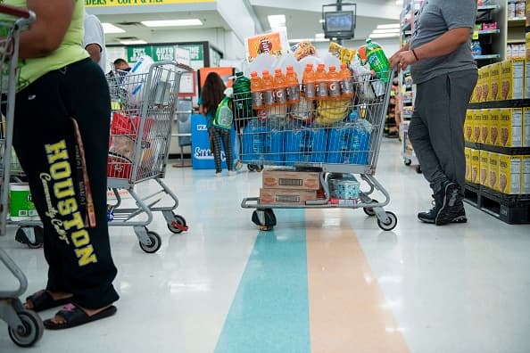 People shop at a Food Town grocery store during the aftermath of Hurricane Harvey on August 30, 2017 in Houston, Texas. - Monster storm Harvey made landfall again Wednesday in Louisiana, evoking painful memories of Hurricane Katrina's deadly strike 12 years ago, as time was running out in Texas to find survivors in the raging floodwaters. (Photo by Brendan Smialowski / AFP) (Photo credit should read BRENDAN SMIALOWSKI/AFP via Getty Images)