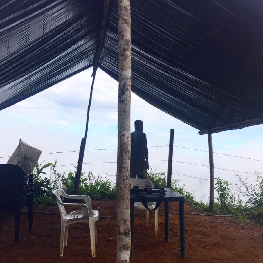 A Farc fighter mans the post outside its disarmament camp – Madrigales, Nariño. Photo by Maximo Anderson.