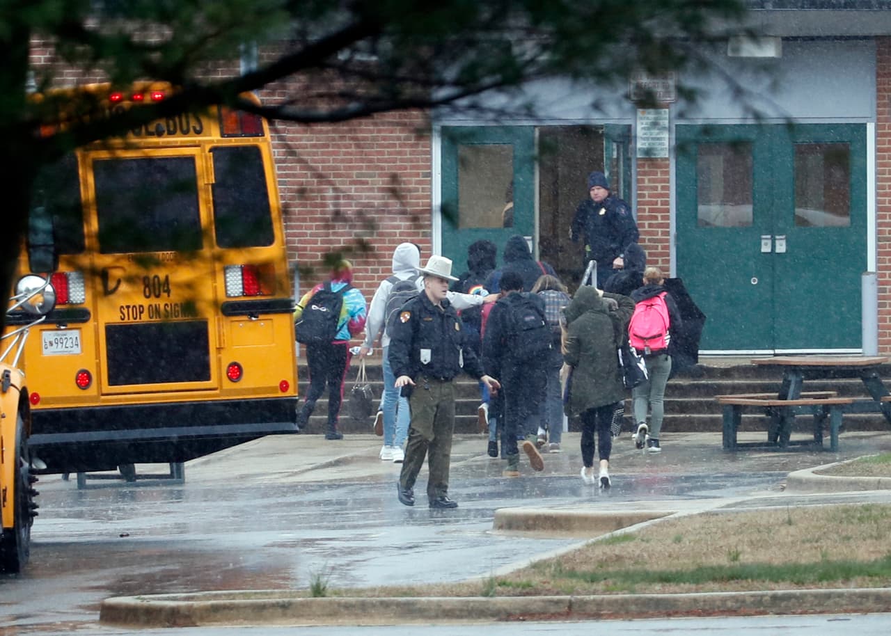 Police move students into a different area of Great Mills High School, the scene of a shooting, Tuesday morning, March 20, 2018 in Great Mills, Md. (AP Photo/Alex Brandon )