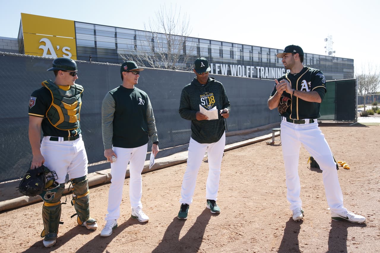 MESA, AZ - FEBRUARY 21: Bullpen Coach Marcus Jensen #59 of the Oakland Athletics works with some of the pitchers and catchers during a spring training workout at Fitch Park on February 21, 2018 in Mesa, Arizona. (Photo by Michael Zagaris/Oakland Athletics/Getty Images) *** Local Caption *** Marcus Jensen