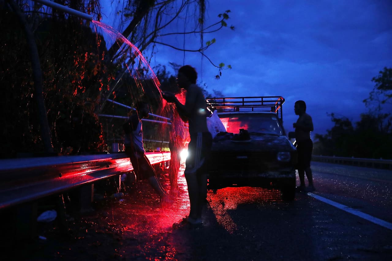 UTUADO, PUERTO RICO - OCTOBER 06: People shower in spring water flowing from a pipe along side a highway since they have no running water in their home after Hurricane Maria passed through on October 6, 2017 in Utuado, Puerto Rico. Puerto Rico experienced widespread damage including most of the electrical, gas and water grid as well as agriculture after Hurricane Maria, a category 4 hurricane, passed through. (Photo by Joe Raedle/Getty Images)
