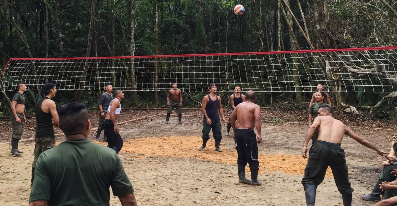 FARC fighters relax on a volleyball court at a rebel camp in southern Colombia, July 2016