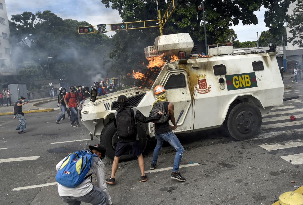 Opposition demonstrators attack a National Guard armored riot control vehicle with homemade bombs. May 3, 2017.
