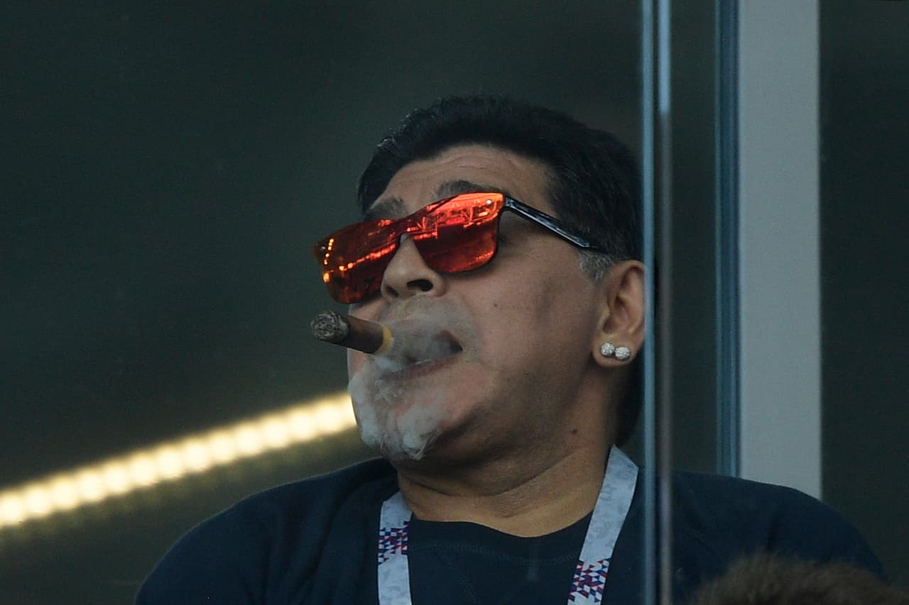 Argentina's football legend Diego Maradona smokes a cigare as he attends the Russia 2018 World Cup Group D football match between Argentina and Iceland at the Spartak Stadium in Moscow on June 16, 2018. (Photo by Juan Mabromata / AFP) / RESTRICTED TO EDITORIAL USE - NO MOBILE PUSH ALERTS/DOWNLOADS (Photo credit should read JUAN MABROMATA/AFP/Getty Images)