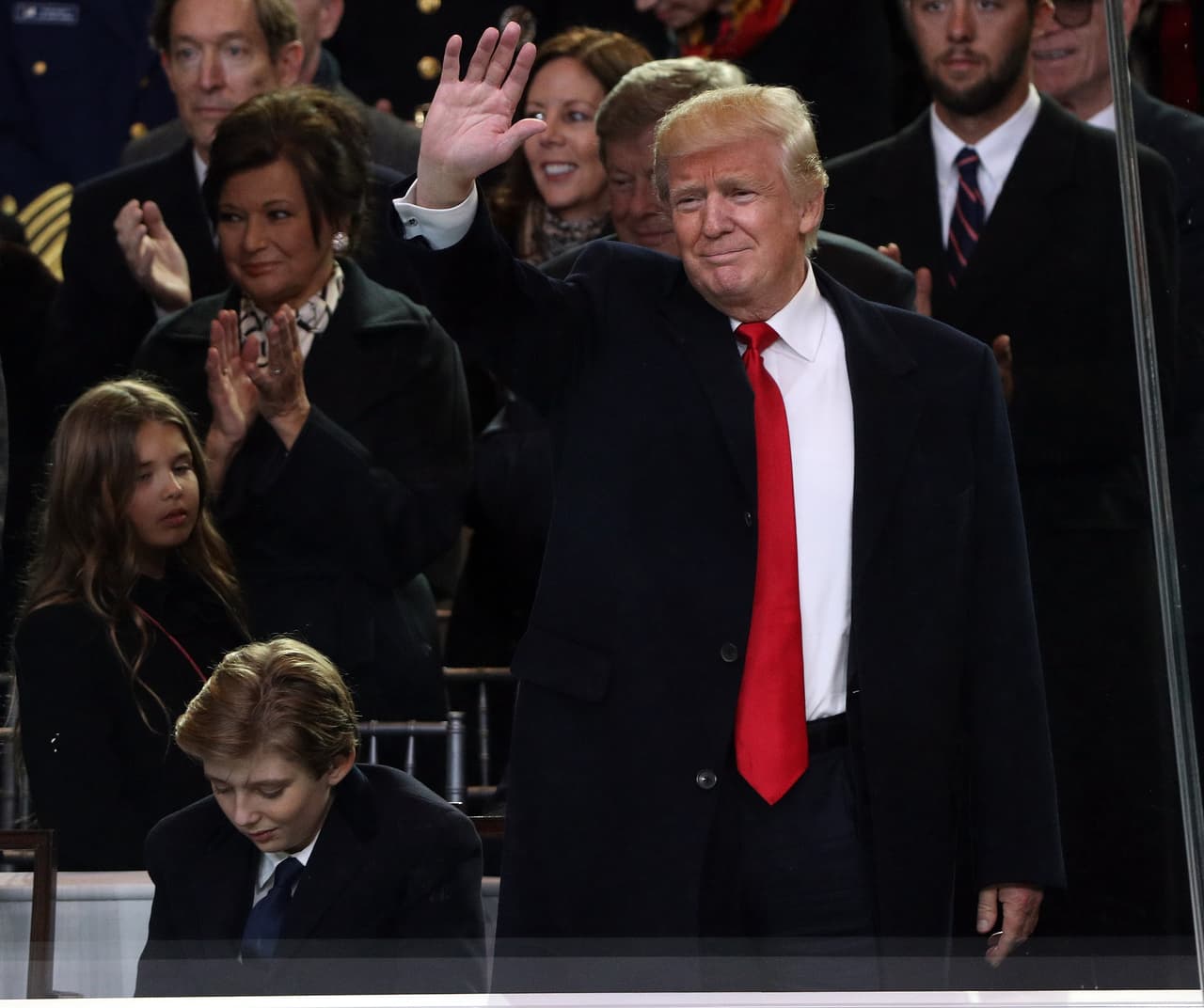 WASHINGTON, DC - JANUARY 20: U.S. President Donald Trump waves as he and Barron Trump watch the Inaugural Parade from the main reviewing stand in front of the White House on January 20, 2017 in Washington, DC. Donald J. Trump was sworn in today as the 45th president of the United States. (Photo by Patrick Smith/Getty Images)